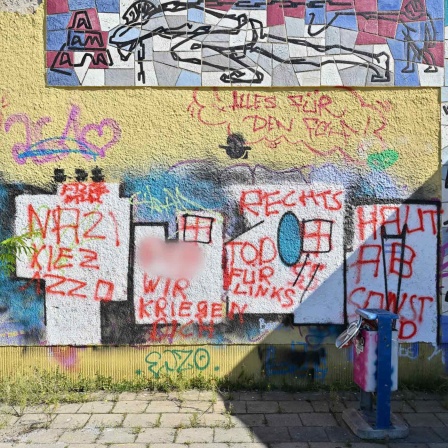 ARCHIV, Eisenhüttenstadt, 4.9.23: Hausfassade am Platz der Jugend mit rechtsextremer Hetze sowie SS-Runen (Bild: picture alliance/dpa/Patrick Pleul)