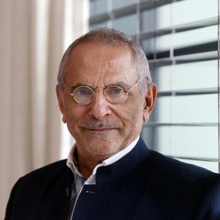 José Ramos-Horta trägt ein schwarzes Sakko und eine Brille. Er steht vor einem Fenster mit Jalousien und schaut in die Kamera.