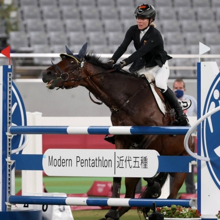 TOKYO, JAPAN - AUGUST 6, 2021: Germany s Annika Schleu competes in the women s individual riding show jumping event during the Modern pentathlon, moderner Fünfkampf competition at the 2020 Summer Olympic Games, Olympische Spiele, Olympia, OS at Tokyo St